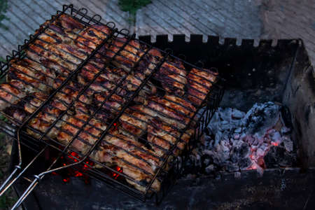 Tasty and fresh juicy cuts of meat on a barbecue grill. Meat skewers being grilled in a barbecueの写真素材