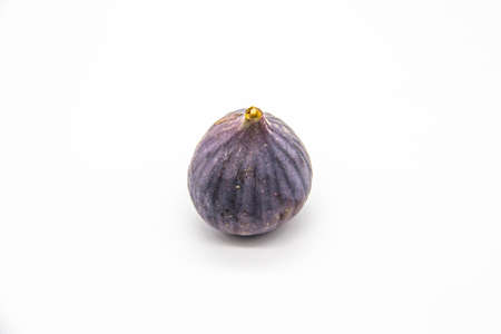 The One fig isolated on a white background. View of ripe purple violet fig.の写真素材