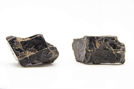 Natural black coals isolated in white background. Two dirty coals stones.