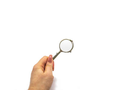 Hand hold an old vintage lorgnette from the middle of the nineteenth century on the white backgroundの写真素材