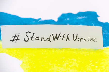 The Ukrainian map in blue and yellow colors with banner on it with words STAND WITH UKRAINE.の写真素材