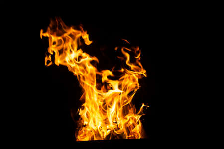 Danger fire on a dark background. Background from fire. Fire pattern can be used in designの写真素材
