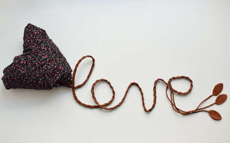 lettering love, image with the help of cloth and leather cord, symbolic imageの写真素材