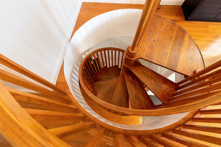 point of view of wooden spiral staircase, harmonic architectural geometry compositionの写真素材