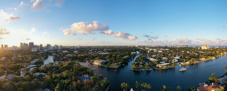 panoramic view of new river in fort lauderdale, miami, waves, boats, docks, tropical plants, buildings and modern housesの写真素材