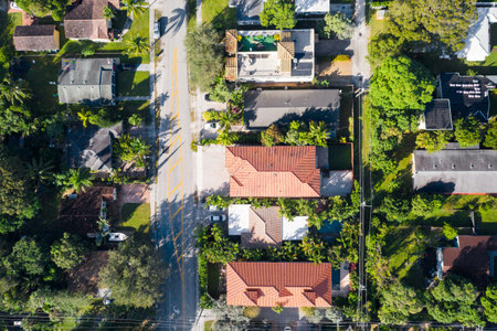 Aerial drone shot of elegant colonial style houses in the Croissant Park neighborhood of Fort Lauderdale, tropical vegetation around,の写真素材