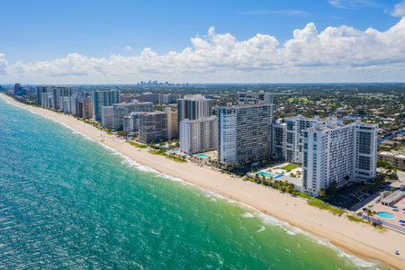 Aerial drone view of the coastline of the Galt Mile neighborhood, in Fort Lauderdale, beach with modern buildings, towers, palms, turquoise sea, blue skyの写真素材