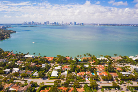 Drone aerial shot of La Gorce neighborhood in Miami Beach, golf course, tropical weather, towers and modern buildings, Biscayne bay, tropical plants and modern houses aroundの写真素材