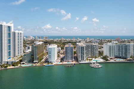 Aerial drone shot of the residential area of West Avenue, in South Beach, Miami, modern buildings and towers facing the sea, piers, swimming pools, summer weather, sunny dayの写真素材