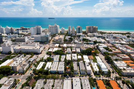Aerial shot of Dorne neighborhood, South Beach, Miami Beach, USA. Suburbs with various modern buildings, towers and condos, palm trees, tropical plants around, sea and blue sky in the backgroundの写真素材