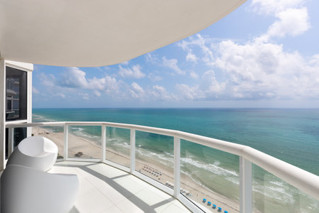 View from balcony in Akoya, of the North Beach beaches, in Miami Beach, turquoise sea, umbrellas, modern buildings and towers around, blue sky, urban and summer landscape, tropicalの写真素材