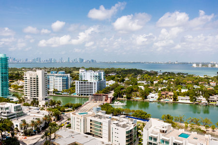 Aerial drone view of the North Beach beaches in Miami Beach, building known as Akoya, turquoise sea, umbrellas, modern buildings and towers around, blue skyの写真素材