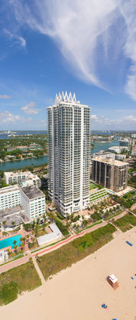 Aerial drone view of the North Beach beaches in Miami Beach, building known as Akoya, turquoise sea, umbrellas, modern buildings and towers around, blue skyの写真素材