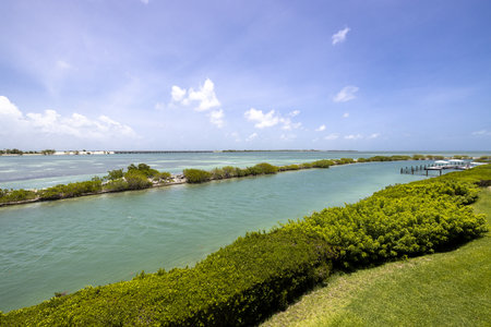 View from a terrace located in Duck Key, Miami, canals and the sea, the Toms Harbor Bridge, docks, intense turquoise color, privet, short grass and tropical vegetation. with bluesの写真素材