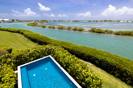 View from a terrace located in Duck Key, Miami, canals and the sea, the Toms Harbor Bridge, docks, intense turquoise color, privet, short grass and tropical vegetation. with bluesの写真素材