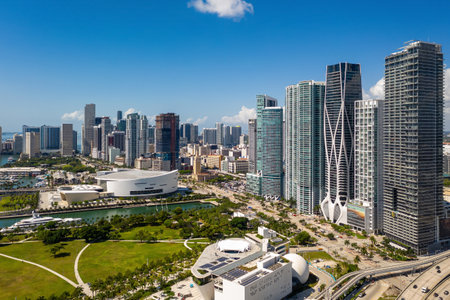Aerial shot from the back of commercial area in Downtown Miami, parks, bridges, cars, brown buildings, museums, towers, piers and blue skyの写真素材