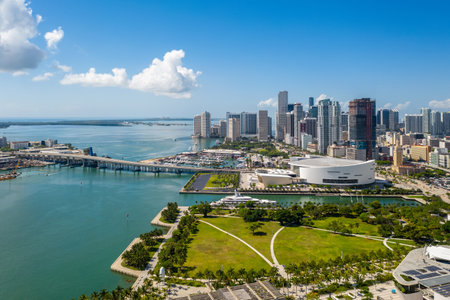 Aerial shot from the back of commercial area in Downtown Miami, parks, bridges, cars, brown buildings, museums, towers, piers and blue skyの写真素材