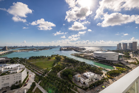Aerial shot of the commercial area in downtown Miami, parks, bridges, cars, modern buildings, museums, towers, piers, bridges and blue skyの写真素材