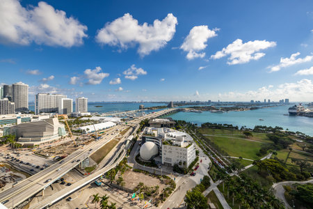 Aerial shot of the commercial area in downtown Miami, parks, bridges, cars, modern buildings, museums, towers, piers, bridges and blue skyの写真素材