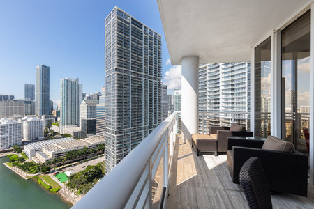 Balcony shot of Brickell Key area, with lots of towers and modern buildings, commercial urban landscape, surrounded by sea and canals, boats sailing, docks, bridges, avenues, blueの写真素材