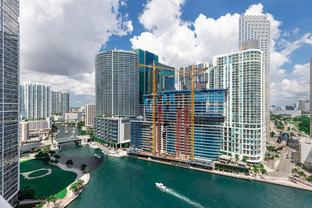Aerial shot from a drone of the Brickell Key area, with a lot of towers and modern buildings, commercial urban landscape, surrounded by sea and canals, boats sailing, piers, bridgeの写真素材