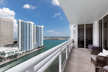 Balcony shot of Brickell Key area, with lots of towers and modern buildings, commercial urban landscape, surrounded by sea and canals, boats sailing, docks, bridges, avenues, blueの写真素材