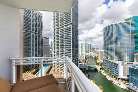 Balcony shot of Brickell Key area, with lots of towers and modern buildings, commercial urban landscape, surrounded by sea and canals, boats sailing, docks, bridges, avenues, blueの写真素材