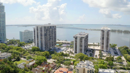 Aerial drone Shots in Miami, USA, commercial area, luxury houses, buildings and mansions, abundant tropical vegetation around and blue sky.の写真素材