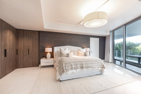 Luxurious, cozy bedroom in a high-end Apartment with natural light, elegant and cozy furniture.の写真素材