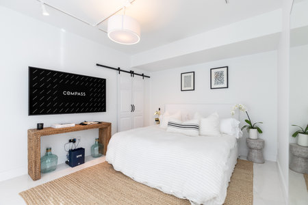 Luxurious, cozy bedroom in a high-end Apartment with natural light, elegant and cozy furniture.の写真素材