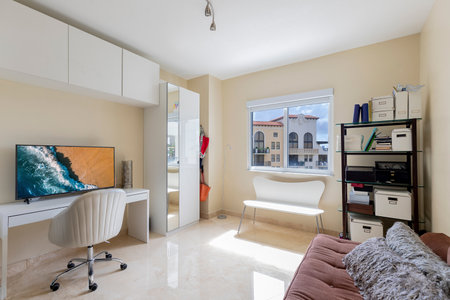 Luxurious, cozy bedroom in a high-end condo with natural light and elegant furniture.の写真素材