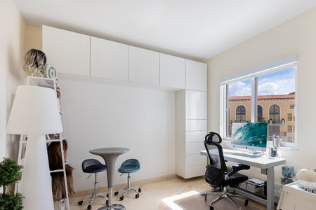 Luxurious, cozy bedroom in a high-end condo with natural light and elegant furniture.の写真素材