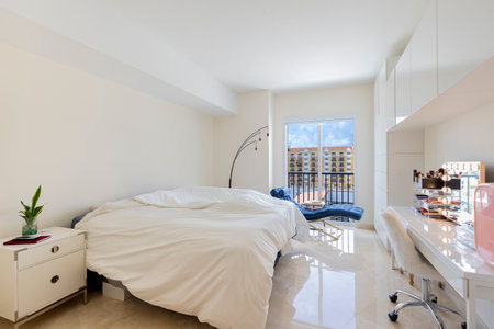 Luxurious, cozy bedroom in a high-end condo with natural light and elegant furniture.の写真素材