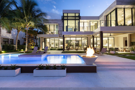USA. Modern building with swimming pool, trees, chairs. Urban landscape with blue reflecting pool, city architecture, and scenic environment.の写真素材