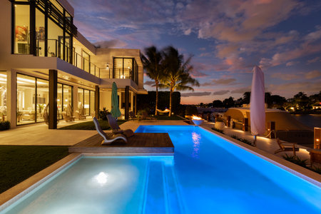 USA. Modern building with swimming pool, trees, chairs. Urban landscape with blue reflecting pool, city architecture, and scenic environment.の写真素材