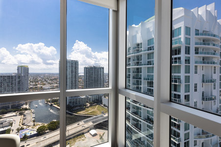 Beautiful photos in the interior of a Apartment located. Luxurious, modern living room with windows panels and views to an elegant city architecture.の写真素材
