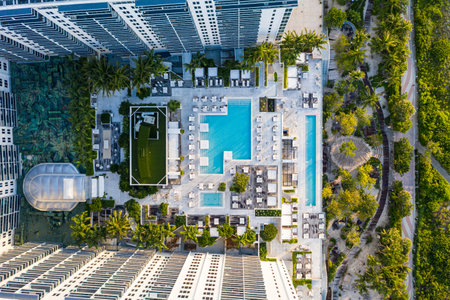Photoshoot Footage of Aerial Drone view in Florida, Usa, showcasing skyline with multiples buildings in a water canal surrounded with abundant vegetantion a perfect blue sky.の写真素材