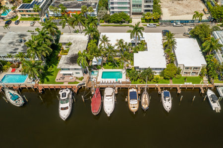Photoshoot Footage of Aerial Drone view in Florida, Usa, showcasing skyline with multiples buildings in a water canal surrounded with abundant vegetantion a perfect blue sky.の写真素材