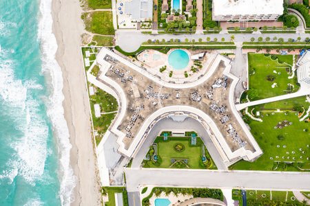 Photoshoot Footage of Aerial Drone view in Florida, Usa, showcasing skyline with multiples buildings in a water canal surrounded with abundant vegetantion a perfect blue sky.のeditorial素材