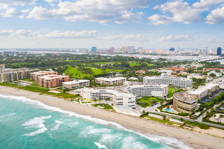 Photoshoot Footage of Aerial Drone view in Florida, Usa, showcasing skyline with multiples buildings in a water canal surrounded with abundant vegetantion a perfect blue sky.のeditorial素材