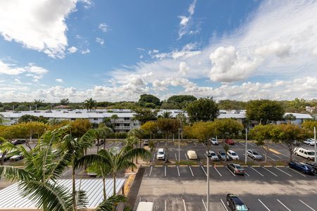 Photoshoot Footage of Aerial Drone view in Florida, Usa, showcasing skyline with multiples buildings in a water canal surrounded with abundant vegetantion a perfect blue sky.のeditorial素材