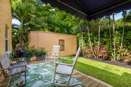Outdoor patio with chair and table in tropical garden. Nobody insideの写真素材