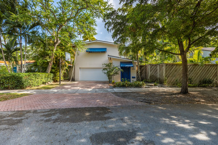 Exterior view of a modern house in the middle of the gardenの写真素材