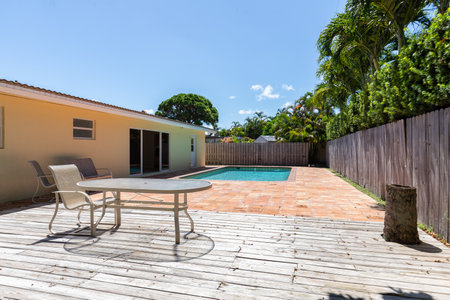 Swimming pool with deck and chairs in a private house. Nobody insideの写真素材