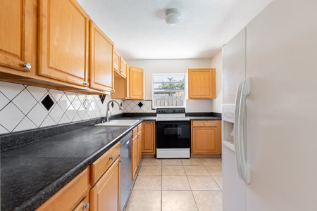 Kitchen interior with island and black granite countertop. Nobody insideの写真素材