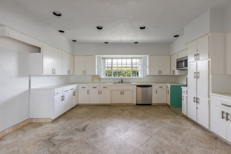 Interior of a new house, kitchen with white cabinets and islandの写真素材