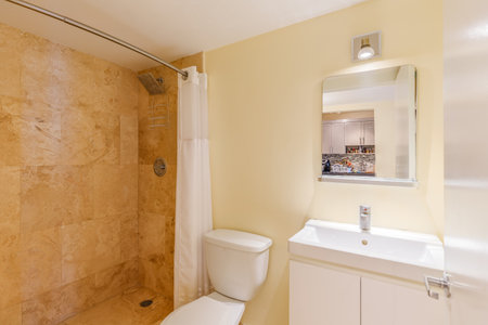 Interior of a new house, bathroom with beige walls and white toiletの写真素材