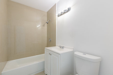 Interior of a bathroom with beige walls and white bathtubの写真素材
