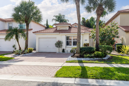 House with a beautiful landscaped yard and a large front door.の写真素材