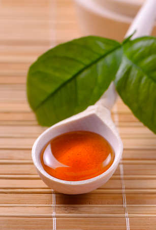 Honey in a wooden spoonfulの写真素材